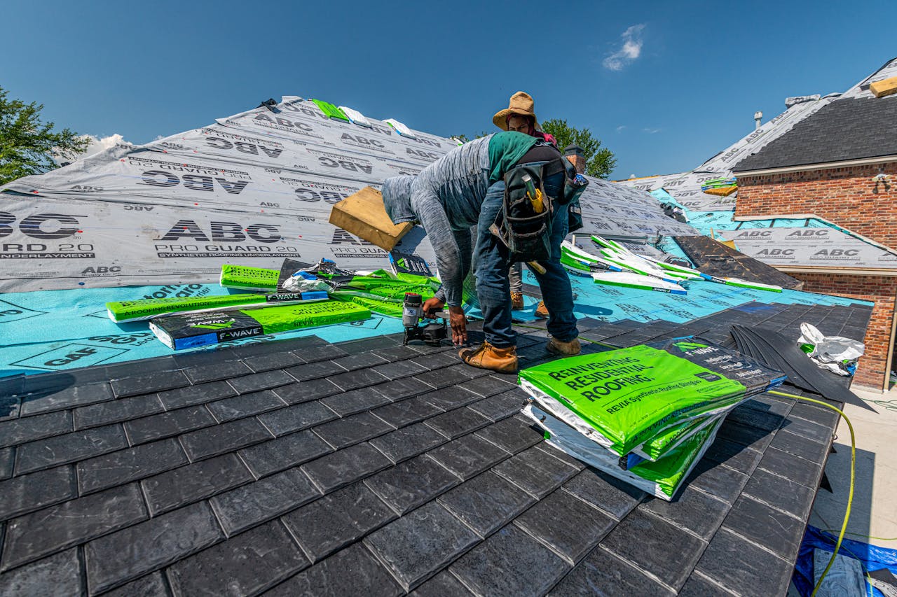 services-06 Workers installing a synthetic slate roof on a brick house in Fort Worth, Texas.